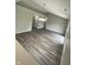 Open-concept living room with wood floors and neutral-toned walls offering lots of natural light at 2717 N Rural St, Indianapolis, IN 46218