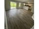Spacious living room with new wood floors, bright lighting, and access to backyard at 2717 N Rural St, Indianapolis, IN 46218