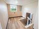 Finished basement with a window view, light wood flooring, and staircase access to other levels at 2721 W 34Th St, Anderson, IN 46011