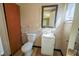 Cozy bathroom featuring a toilet, vanity with a sink, and a wall-mounted mirror at 2721 W 34Th St, Anderson, IN 46011
