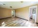 A simple, well-lit bedroom with wood-look flooring and easy access to an attached bathroom at 2721 W 34Th St, Anderson, IN 46011