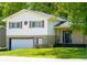 Charming home with a two-car garage and stone facade, nestled among mature trees at 2721 W 34Th St, Anderson, IN 46011