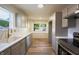 A newly renovated kitchen features sleek gray cabinetry, modern stainless steel appliances, and a bright, airy feel at 2721 W 34Th St, Anderson, IN 46011