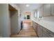 Contemporary kitchen boasts stainless steel appliances, subway tile backsplash, and stylish gray cabinetry with gold hardware at 2721 W 34Th St, Anderson, IN 46011