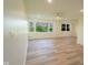 Spacious living room with modern flooring, recessed lighting, and a view of the lush outdoor greenery at 2721 W 34Th St, Anderson, IN 46011