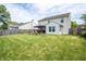 Spacious backyard with a well-manicured lawn, wooden fence, and a patio with hot tub at 2730 Foxbriar Pl, Indianapolis, IN 46203