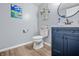Bathroom with a blue vanity, modern fixtures, toilet, and laminate flooring at 2730 Foxbriar Pl, Indianapolis, IN 46203
