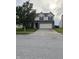 Traditional two-story home with a well-manicured lawn, two-car garage, and basketball hoop in the driveway at 2730 Foxbriar Pl, Indianapolis, IN 46203