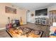 Cozy living room with laminate floors, guitars, HD TV, and motorcycle-themed rug at 2730 Foxbriar Pl, Indianapolis, IN 46203