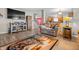 Open-concept living room with sofas, laminate floors, TV, access to kitchen, and staircase at 2730 Foxbriar Pl, Indianapolis, IN 46203