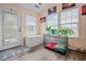Sunroom with large windows, laminate flooring, and a dog kennel at 2730 Foxbriar Pl, Indianapolis, IN 46203