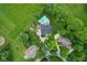 An overhead view reveals a pool, a house with a gray roof, and surrounding trees at 2953 Foxborough Dr, Greenwood, IN 46143