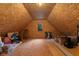 Unfinished attic space, showcasing potential for storage or customization with a small window at 2953 Foxborough Dr, Greenwood, IN 46143