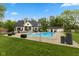 Private pool in a sprawling backyard with a patio, poolside seating, and well-manicured lawn at 2953 Foxborough Dr, Greenwood, IN 46143