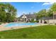 A large in-ground pool is featured in this spacious backyard surrounded by lush landscaping at 2953 Foxborough Dr, Greenwood, IN 46143