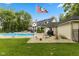 Secluded backyard featuring a pool, patio, flag pole, and mature trees at 2953 Foxborough Dr, Greenwood, IN 46143