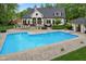Beautiful home with a large backyard, featuring a pool, deck, and lush greenery at 2953 Foxborough Dr, Greenwood, IN 46143