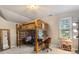 Charming bedroom featuring a custom-built wooden loft bed with integrated desk and cozy seating area at 2953 Foxborough Dr, Greenwood, IN 46143