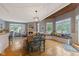 The bright dining area is decorated with a wood table, upholstered bench, and backyard view at 2953 Foxborough Dr, Greenwood, IN 46143
