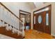 Inviting foyer with hardwood floors, staircase, and a decorative front door with leaded glass at 2953 Foxborough Dr, Greenwood, IN 46143
