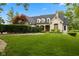 Beautifully landscaped front yard with lush green lawn and mature trees at 2953 Foxborough Dr, Greenwood, IN 46143