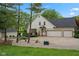 A three-car garage attached to this beautiful home with a manicured lawn and landscaped beds at 2953 Foxborough Dr, Greenwood, IN 46143