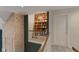 Second story hallway featuring a brick accent wall, bookshelf, and white trim at 2953 Foxborough Dr, Greenwood, IN 46143