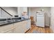 Charming kitchen featuring stainless steel sink, white brick wall, and hardwood floors at 2953 Foxborough Dr, Greenwood, IN 46143