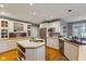 Bright kitchen featuring white cabinetry, stainless steel appliances, a central island, and hardwood flooring at 2953 Foxborough Dr, Greenwood, IN 46143