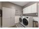 Convenient laundry room with modern appliances, ample storage, and stylish gray and white decor at 2953 Foxborough Dr, Greenwood, IN 46143
