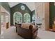 Elegant living room with a soaring ceiling, large arched windows, and a cozy fireplace at 2953 Foxborough Dr, Greenwood, IN 46143