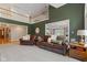 Spacious living room featuring soaring ceilings, hardwood floors, and an open view to the kitchen at 2953 Foxborough Dr, Greenwood, IN 46143