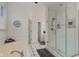 Bright bathroom featuring a glass-enclosed shower, jacuzzi bathtub, and black and white tile floor at 2953 Foxborough Dr, Greenwood, IN 46143