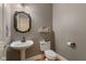 Charming powder room with a pedestal sink, decorative mirror, and stylish wall color at 2953 Foxborough Dr, Greenwood, IN 46143