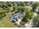 Aerial view of a well-maintained home with a spacious yard, pool, deck, and mature trees at 2971 N Buck Creek Rd, Greenfield, IN 46140