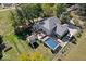 Aerial shot of the home showcasing a backyard with pool, deck, outdoor playhouse, and lush green lawn at 2971 N Buck Creek Rd, Greenfield, IN 46140