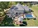 Gorgeous aerial view of home featuring backyard deck, hot tub, in-ground pool, playhouse, and a spacious lawn at 2971 N Buck Creek Rd, Greenfield, IN 46140