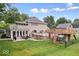 Backyard view featuring a deck, patio, and lush green lawn for outdoor enjoyment at 2971 N Buck Creek Rd, Greenfield, IN 46140