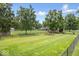 Large, fenced backyard showcasing a lush green lawn and mature trees at 2971 N Buck Creek Rd, Greenfield, IN 46140