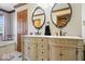Bathroom with a double vanity, elegant mirrors, and tiled walls leading to a tub at 2971 N Buck Creek Rd, Greenfield, IN 46140