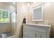 Well-lit bathroom featuring a marble countertop, white cabinets, and tiled shower at 2971 N Buck Creek Rd, Greenfield, IN 46140