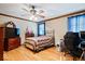 Bedroom featuring wood floors, crown molding, and a quilt with neutral tones at 2971 N Buck Creek Rd, Greenfield, IN 46140