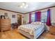 A comfortable bedroom with hardwood floors, a ceiling fan, and a cozy quilt on the bed at 2971 N Buck Creek Rd, Greenfield, IN 46140