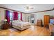 Bright bedroom with hardwood floors, ceiling fan, and a cozy quilt on the bed at 2971 N Buck Creek Rd, Greenfield, IN 46140