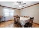 Formal dining room with wooden table and chairs, complemented by natural light and hardwood floors at 2971 N Buck Creek Rd, Greenfield, IN 46140