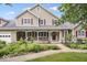 Charming two-story home with a well-manicured lawn, lovely garden, and inviting front porch at 2971 N Buck Creek Rd, Greenfield, IN 46140