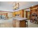 Spacious kitchen with an island, wooden cabinets, and a dining area with natural light at 2971 N Buck Creek Rd, Greenfield, IN 46140
