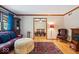 Cozy living room with hardwood floors, leather sofa, and fireplace, offering a warm and inviting atmosphere at 2971 N Buck Creek Rd, Greenfield, IN 46140