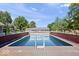 Backyard features an in-ground pool surrounded by a deck and lush greenery, perfect for relaxation at 2971 N Buck Creek Rd, Greenfield, IN 46140