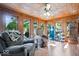 Cozy sunroom with wood paneled walls, comfortable seating, and natural light at 2971 N Buck Creek Rd, Greenfield, IN 46140